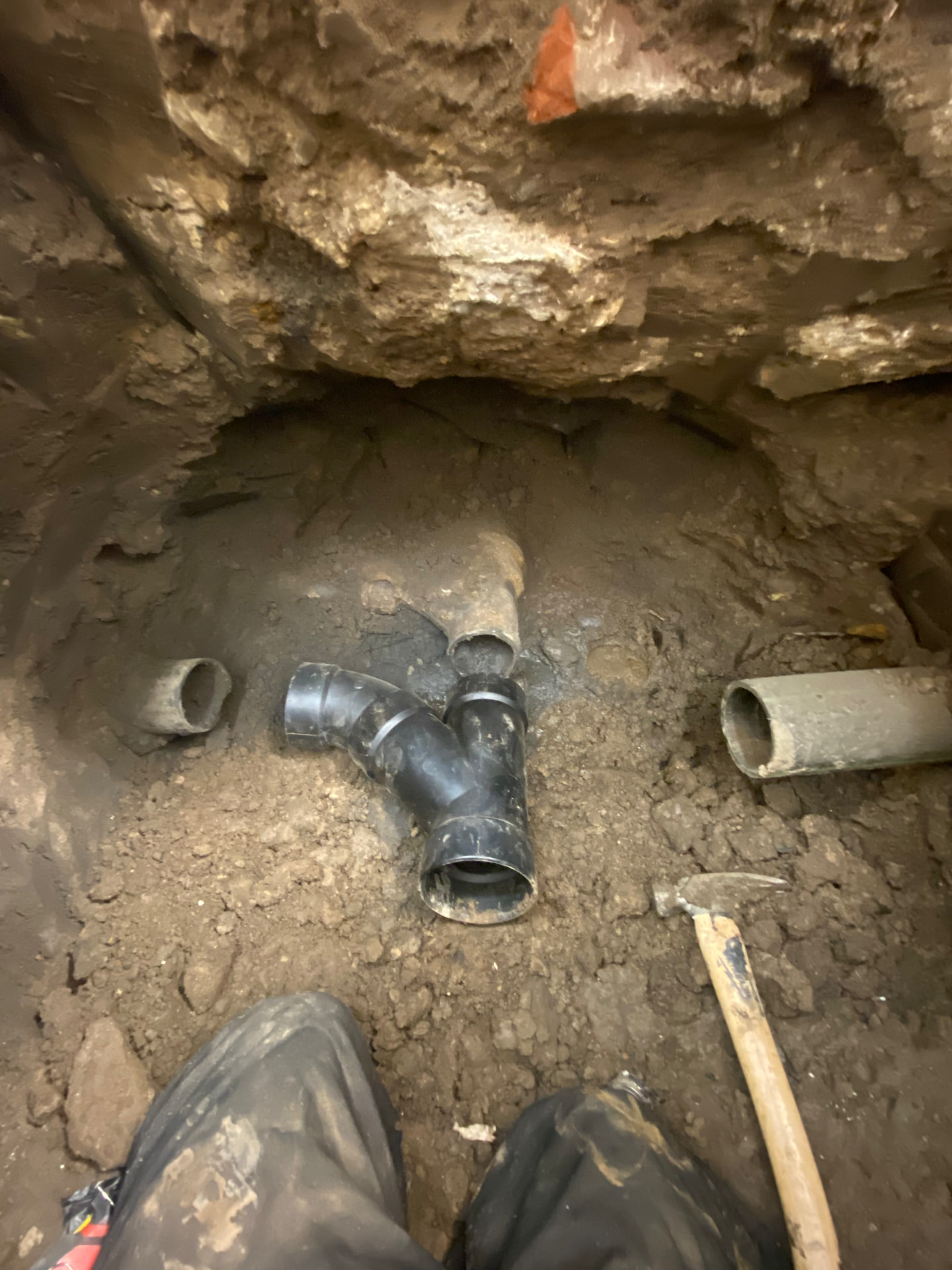 Sewer line replacement in progress under a concrete slab